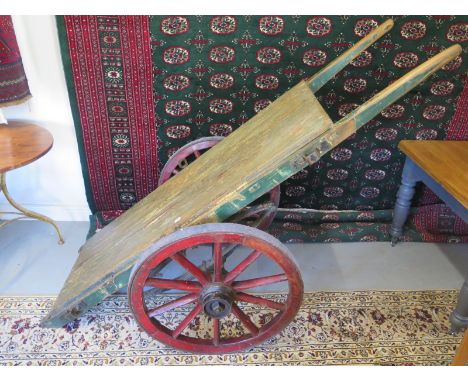 A late 19th Century handcart in original paint,  mounted on large springs and with original wheel spanner to remove wheels, u