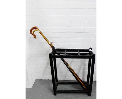 Ebonised stick stand together with three walking sticks, 55 x 52cm, (4) 