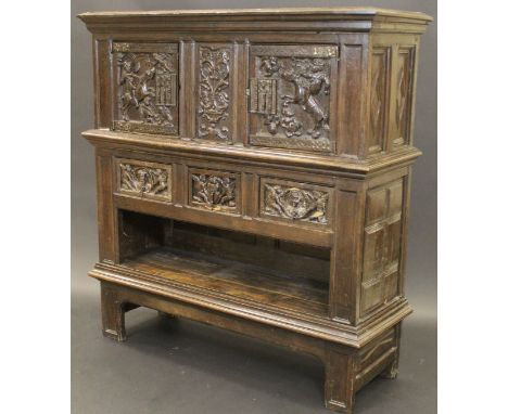 A 17th Century Flemish walnut and oak cabinet with ogee moulded cornice above two high relief carved cupboard doors featuring