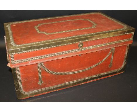 A 19th Century Chinese export camphor wood travel trunk covered in red leather with heavy brass bindings and studs, the lid o