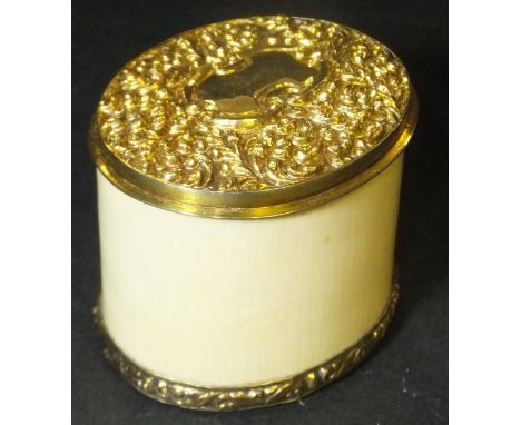A 19th Century ivory box of oval form with foliate decorated yellow metal lid and matching mount to base, approx 4 cm high CO