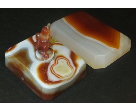 An agate bell push the rectangular base with canted edge, bearing squirrel button, together with an agate plinth base with ca