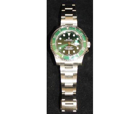 A steel cased Rolex Oyster Perpetual Date Submariner Superlative Chronometer gentleman's wristwatch with green face and dial,