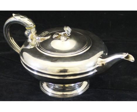 A William IV silver teapot of squat circular form, the lid set with floral finial and the handle with ivory spaces and acanth