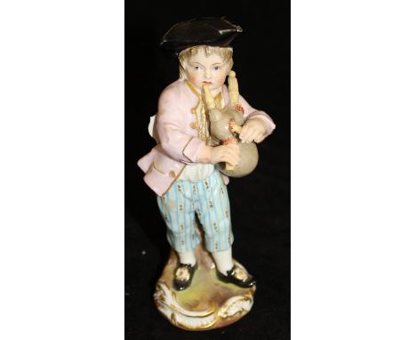 A 19th Century Meissen figure of young boy in tri-corn hat playing bagpipes by tree stump, bears blue crossed swords mark to 