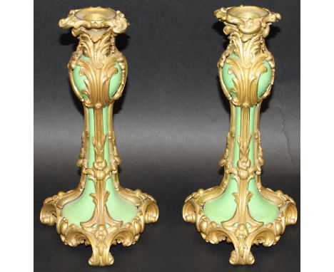 A pair of late 19th Century gilt brass and pale green glazed pottery candlesticks in the Rococo taste, 24.5 cm high CONDITION