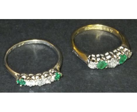 An 18 carat gold and platinum set five stone ring with three diamonds, approx 0.09 carats total, interspersed by two emeralds