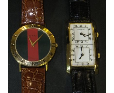 A Gucci gold plated cased writswatch with original leather strap, serial number 0337962, model number 3000.2.M with green lea