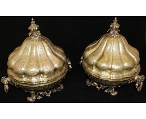 Two similar 19th Century silver plated warmer tureens with pierced decoration and heavy acanthus decorated handles, raised on