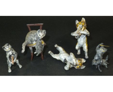 A collection of five painted lead flash metal figures of cats, three playing musical instruments, the other beating a further