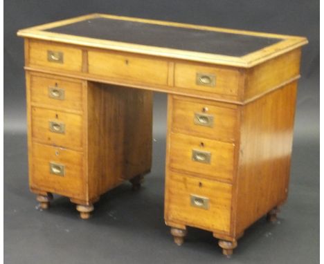 A Victorian mahogany campaign style pedestal desk with black leatherette inset top above a single long drawer with brass camp