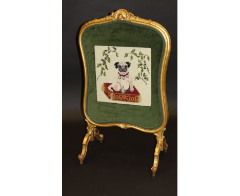 A late Victorian carved giltwood framed fire screen in the Louis XV taste, decorated with a later needlework study of a pug s
