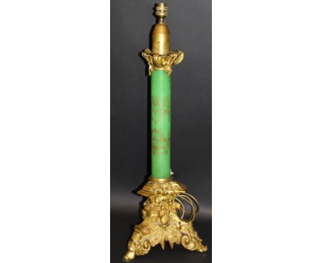 A Victorian gilt brass and pale green glass and gilt decorated table lamp in the Gothic Revival taste, the original candle ho