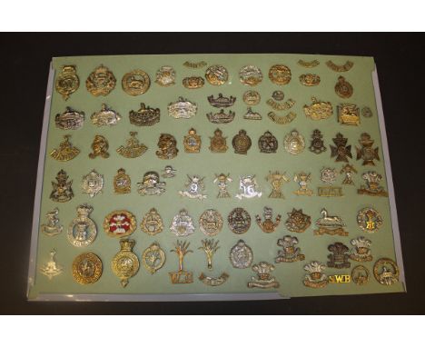 Eight boards and a small tub of military cap badges, collar dogs and shoulder badges, to include examples from Scottish Regim