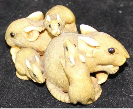 A late 19th Century Japanese Meiji Period carved ivory netsuke in the form of a family of rats, the adult eating seeds, signe