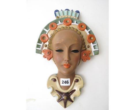 A rare 1930s Goldscheider pottery, Austrian, wall mask of a young woman waving a headdress, printed Goldscheider backstamp an