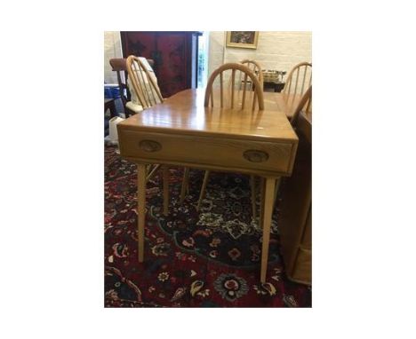 A light Ercol side table having one single inset drawer standing on tapering legs, 29 1/4 high x 27 wide x 18 1/4 deep