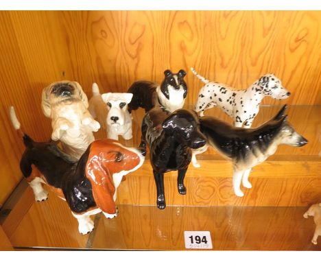 A collection of seven Beswick dog figurines to include a Dalmatian