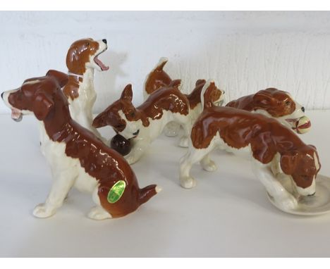 A group of Beswick pottery dog figures, each in playful post (6)