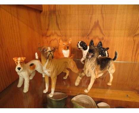 A collection of five Beswick dog figurines to include a Boxer