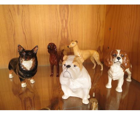 A collection of five Beswick dog figurines to include a Corgi