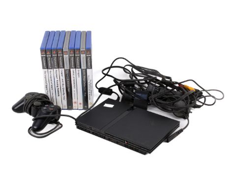 A Playstation 2 and nine boxed games. The Playstation including a console, AC adaptor, AC cords, Analog Controller, AV cable,