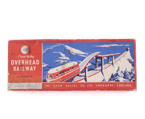 A Chad Valley tinplate clockwork Overhead Railway set. Containing a cream and blue clockwork car, blue track and red supports