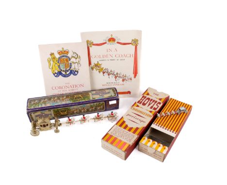 An assortment of Royal Coronation related toys and memorabilia. Comprising a boxed diecast Royal State Coach, a Moko by Lesne