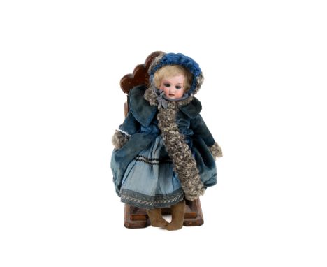 An Armand Marseille doll. Having a bisque porcelain head with blue sleeping eyes, a open mouth and painted features, blond wi