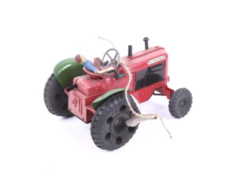 A Tri-ang Minic No. 2 clockwork tractor. Plastic red body with green wings, complete with farmer. 