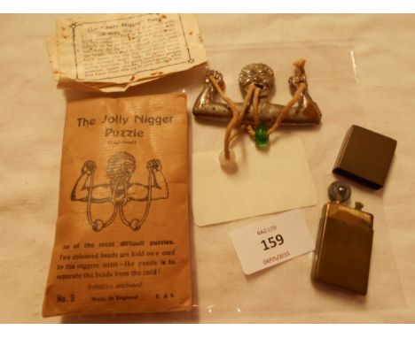 A trench lighter and a vintage novelty puzzle 'The Jolly Nigger Puzzle'