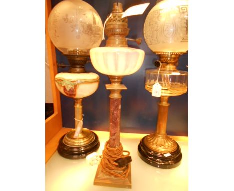A 20th C Victorian style table lamp with opalescent glass reservoir raised on brass and marble column support 