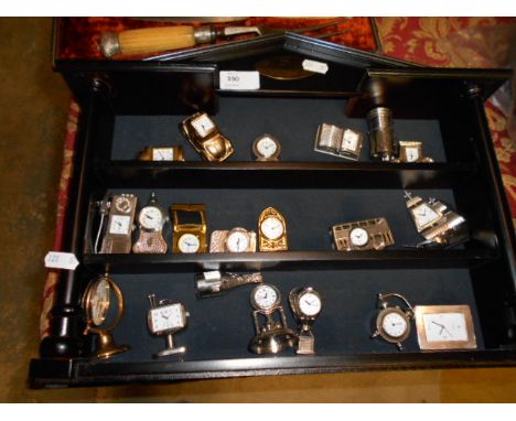 A three-tiered hanging shelf with a quantity of novelty watches