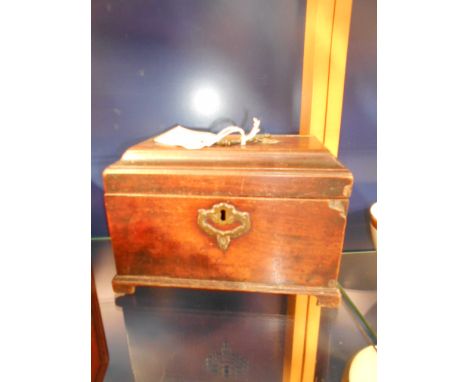 A late 18th C mahogany sarcophagus shaped tea caddy with ornate brass handles and escutcheon 