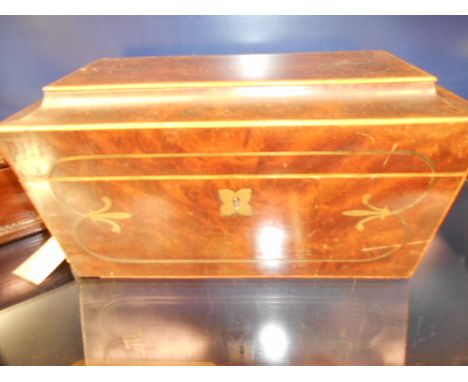 A 19th C walnut and brass inlaid sarcophagus tea caddie having lion mask and ring handles and velvet lined interior 