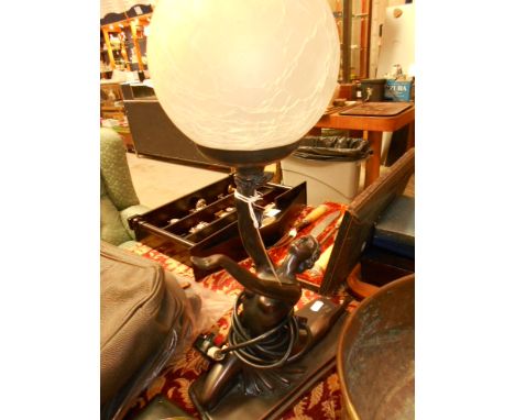 A bronzed Art Deco style lamp featuring a female dancer holding a globe