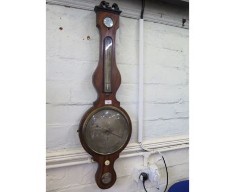 An early 19th century mahogany banjo barometer, with swan neck pediment, mercury thermometer and silvered dial over a spirit 