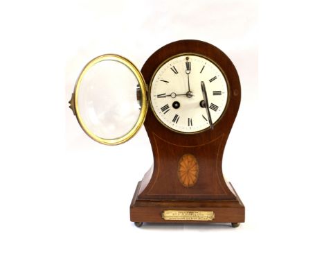 An Edwardian mahogany and patera inlaid mantel clock, of waisted form with enamel dial and presentation plaque, the French tw