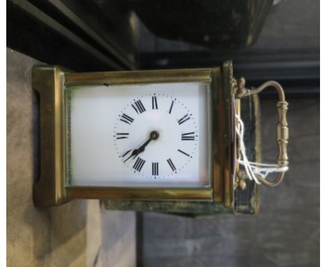 A brass carriage timepiece clock, of conventional form with oval panel to the top and leather case, 14.5 cm high 