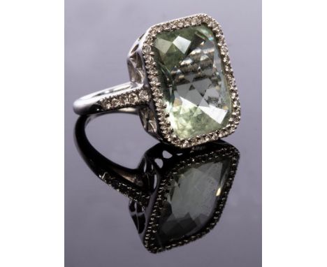 Kiki McDonough, a green amethyst and diamond cluster ring, the central stone of faceted rectangular form, to a surround of di