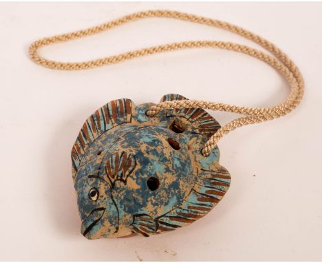 Neil Ions (born 1949), an earthenware ocarina in the form of a flat fish, slip decorated, painted signature, 9cm long CONDITI