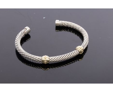 David Yurman, a silver and gold cable bangle, with two 14ct yellow gold collars, signed, approximately 29gm CONDITION REPORT: