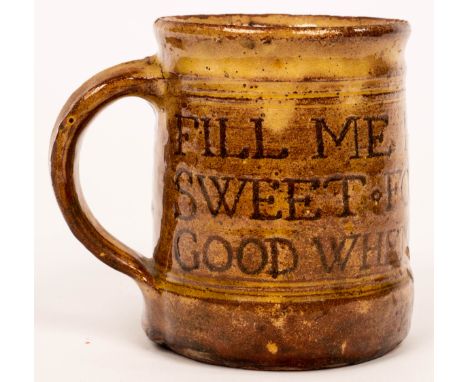 Michael Cardew (1901-1983), a Winchcombe Pottery slipware mug, incised lettering 'Fill me full of liquor sweet for that is go