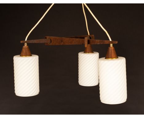 A 1970s style pendant light, the triangular wooden frame suspending three opaque glass shades of spiral cylindrical form, the