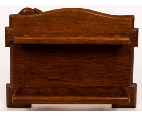 A Robert 'Mouseman' Thompson oak pipe rack, with six sections and an arched top, carved mouse signature, 28cm wide CONDITION 