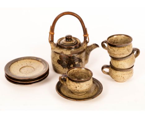 Warwick Parker (born 1940), a stoneware teapot with temmoku and ash glaze, impressed mark, four teacups and matching saucers 