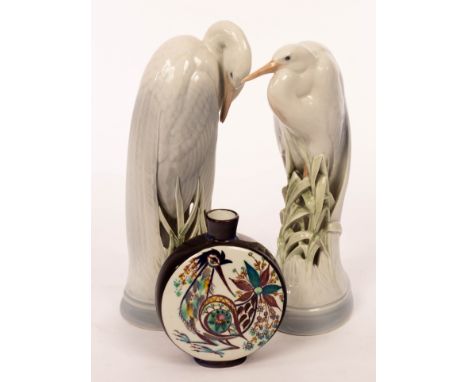 A pair of Royal Copenhagen herons, 28.5cm high and a moon flask with peacock design by Marianne Johnson, 13.5cm high CONDITIO