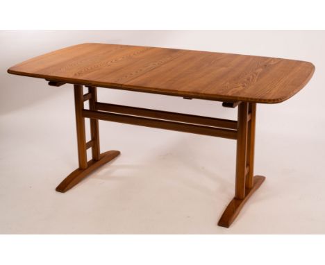 Ercol, a light elm extending dining table, the curved corners with incised decoration, on twin stretchers and twin chamfered 