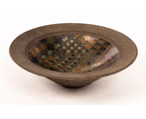 John Wheeldon (born 1950), a black stoneware bowl with lustre geometric designs to the well, impressed mark, 16.5cm diameter 