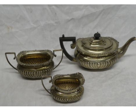 An Edward VII silver three-piece tea set comprising oval teapot with gradrooned decoration and ebonised angular handle, Chest